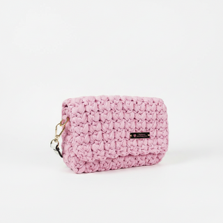 A soft pink, handmade crochet shoulder bag.