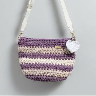 Striped crochet bag with a heart charm on a gray background