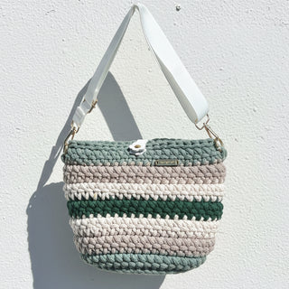 Crocheted handbag with a strap against a white background