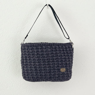 Dark blue textured handbag with a strap on a white background