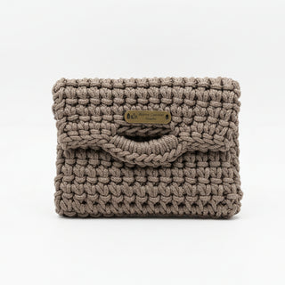 Textured brown pouch with a gold tag on a light gray surface