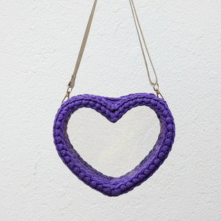 Purple heart-shaped bag with a strap on a white background